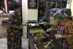 Community-kitchen-staffs-using-necessary-safety-gears-while-serving-food